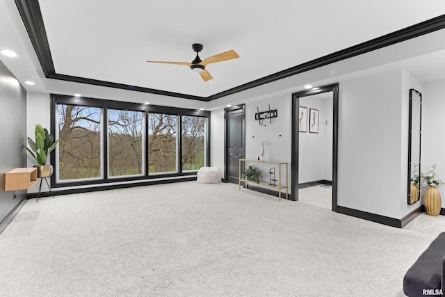 unfurnished living room featuring light carpet, baseboards, ornamental molding, and a tray ceiling