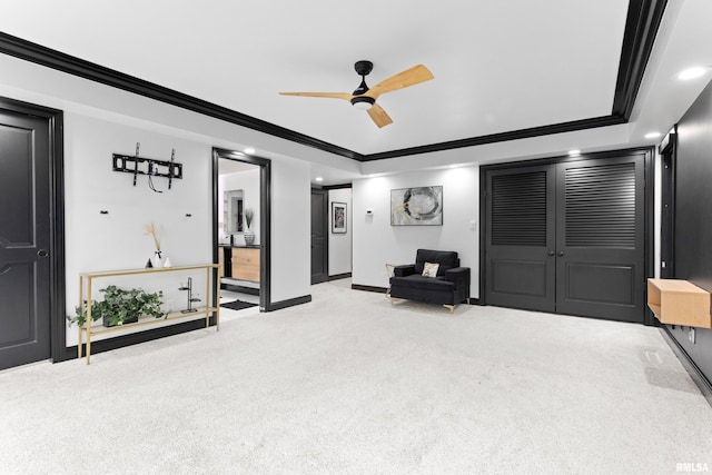 sitting room with ceiling fan, recessed lighting, light carpet, baseboards, and ornamental molding