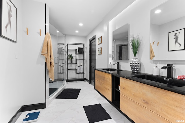 bathroom featuring recessed lighting, a sink, marble finish floor, double vanity, and a stall shower