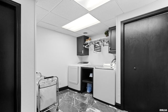 washroom with cabinet space, baseboards, marble finish floor, and washer and clothes dryer