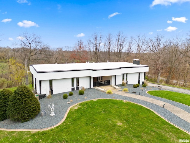 exterior space featuring a front lawn and stucco siding