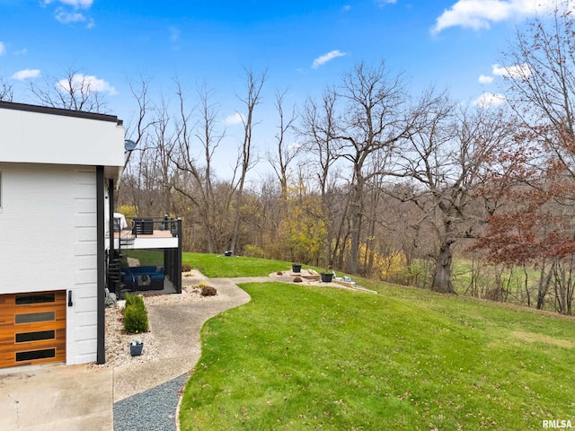 view of yard featuring a garage, stairs, and a fire pit