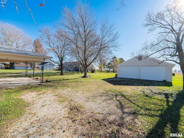 view of yard with a garage and an outdoor structure