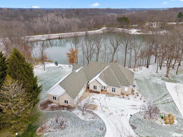 snowy aerial view with a water view