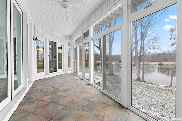 unfurnished sunroom with a water view