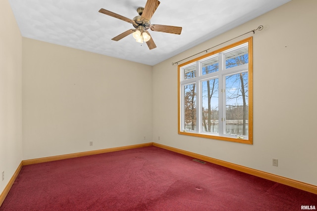 unfurnished room with carpet flooring and ceiling fan