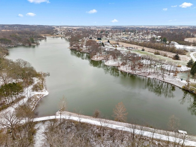 snowy aerial view featuring a water view