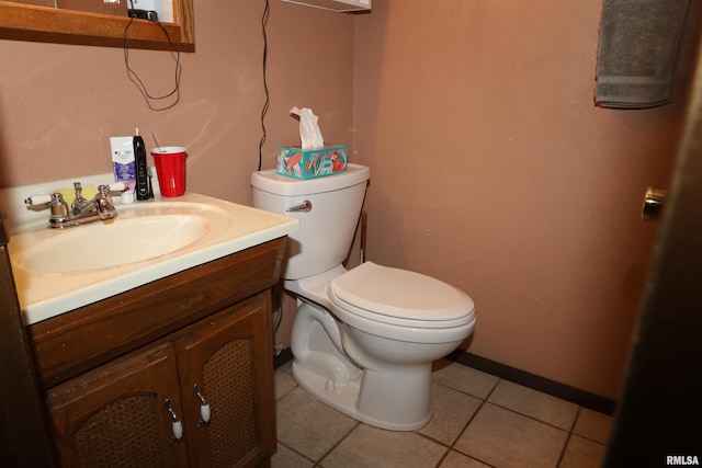 bathroom featuring tile patterned floors, vanity, and toilet