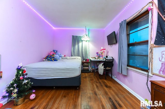 bedroom with dark wood-type flooring