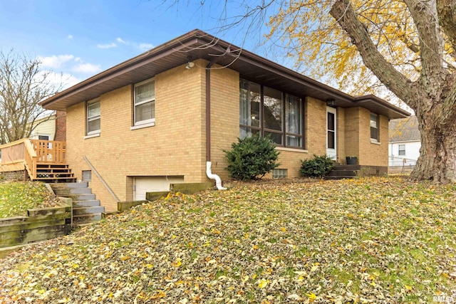 view of side of property featuring a wooden deck