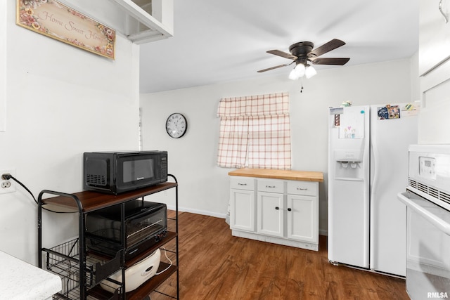 kitchen with wood counters, white appliances, dark wood-type flooring, ceiling fan, and white cabinetry