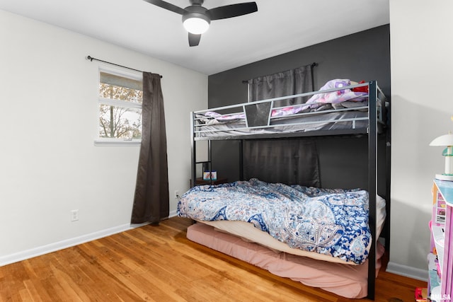 bedroom featuring hardwood / wood-style flooring and ceiling fan