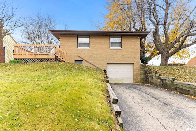 exterior space featuring a wooden deck, a front lawn, and a garage