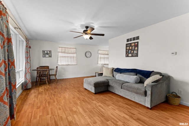 living room featuring ceiling fan and light wood-type flooring