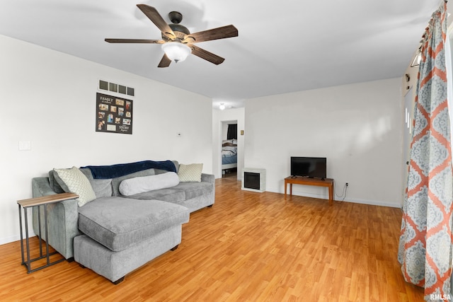 living room with ceiling fan and wood-type flooring