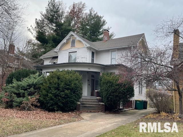 704 S Lafayette St, Macomb, IL 61455 - victorian house featuring a chimney and a porch