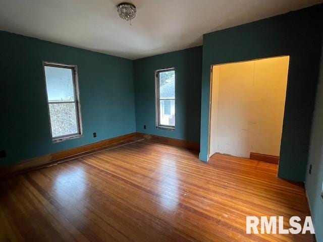 704 S Lafayette St, Macomb, IL 61455 - unfurnished bedroom with wood finished floors and baseboards