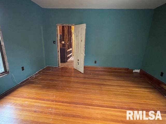 unfurnished room featuring hardwood / wood-style floors