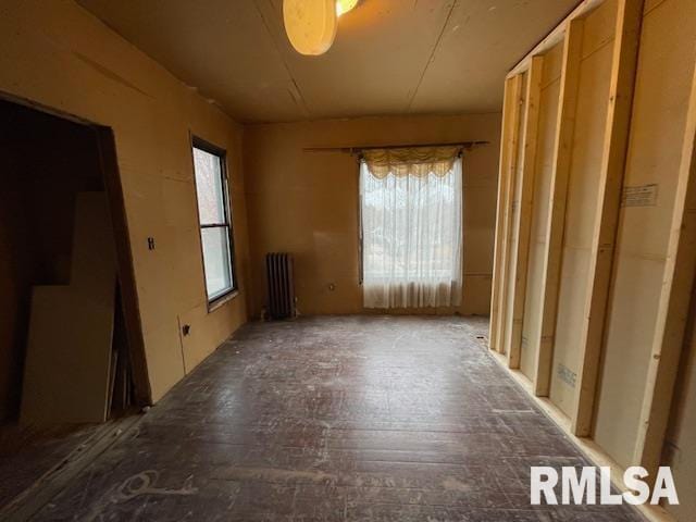 misc room with hardwood / wood-style floors and radiator heating unit