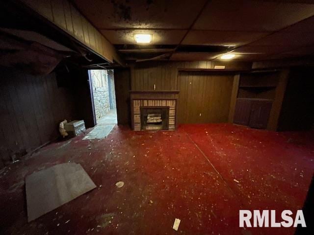 basement featuring a brick fireplace