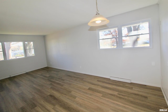 empty room with plenty of natural light and dark hardwood / wood-style flooring