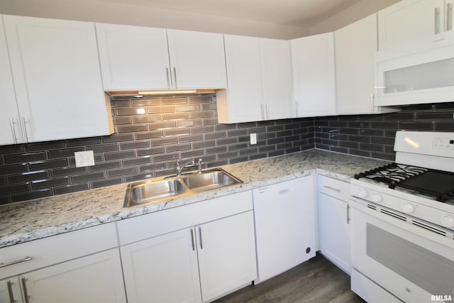 kitchen with white cabinets, white appliances, and sink