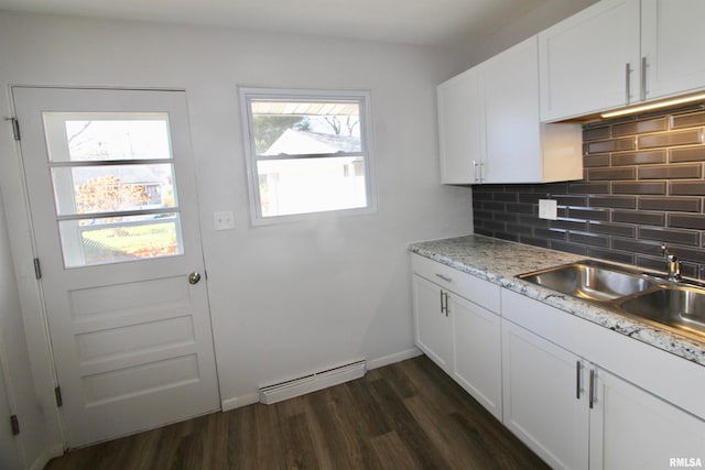 kitchen with light stone countertops, baseboard heating, tasteful backsplash, dark hardwood / wood-style floors, and white cabinets