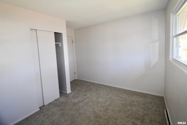 unfurnished bedroom with carpet flooring and a closet