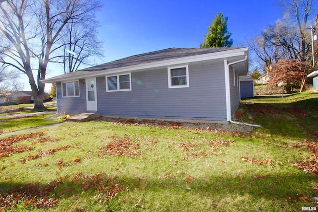 view of side of home featuring a yard