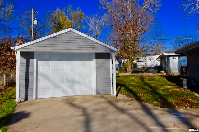 garage with a yard and central AC