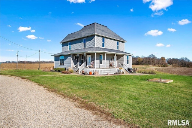 farmhouse-style home with a porch, a front yard, and a rural view