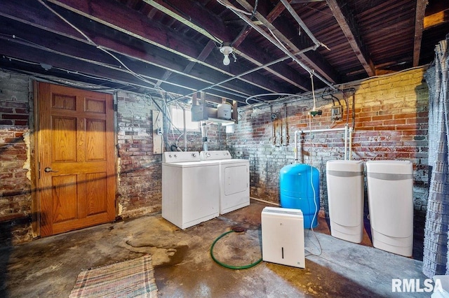 basement with washer and dryer and brick wall