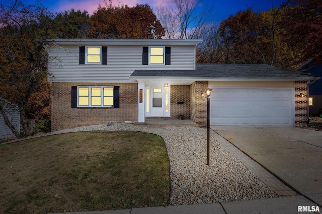 front of property featuring a garage and a yard