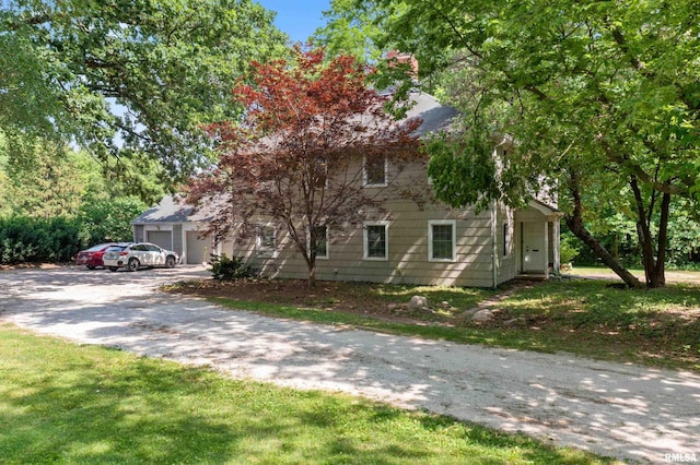 view of front of home with a garage and a front lawn