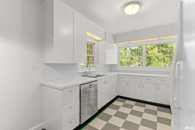 kitchen featuring white cabinetry, dishwasher, white fridge, and sink