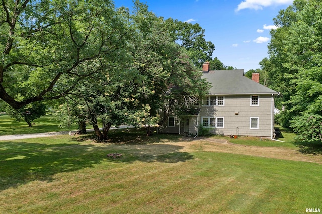 back of property featuring a yard