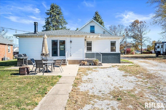 back of property featuring a yard, a patio, and central AC