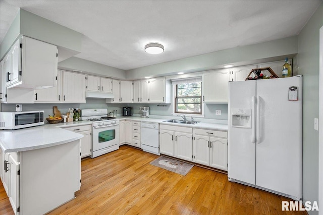 kitchen with light wood-type flooring, white appliances, white cabinetry, and sink