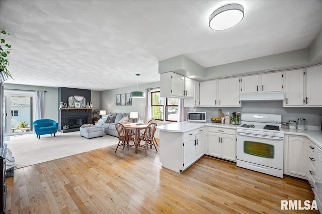 kitchen featuring white cabinets, white appliances, and light wood-type flooring