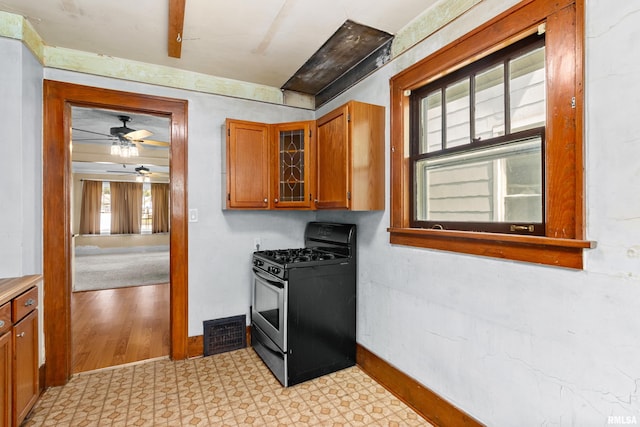 kitchen featuring ceiling fan and stainless steel gas range oven