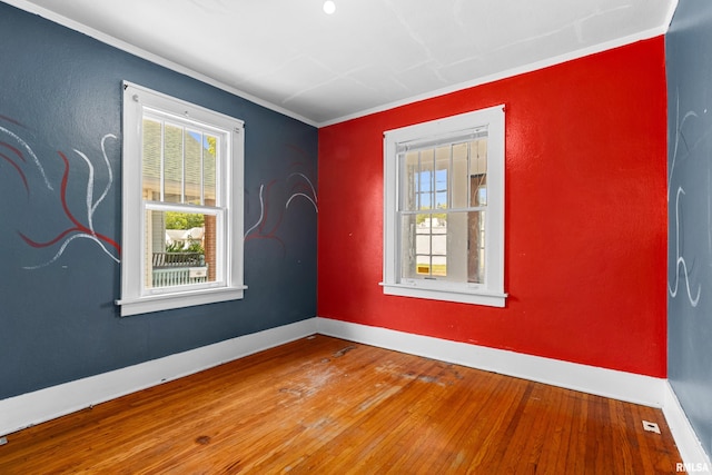 unfurnished room with crown molding and hardwood / wood-style flooring