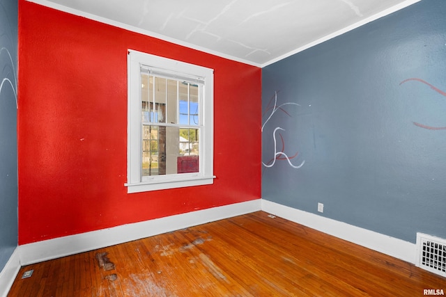 spare room featuring ornamental molding and wood-type flooring