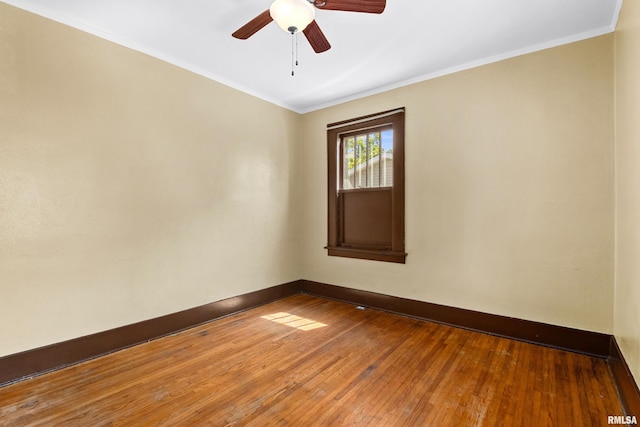 empty room featuring ceiling fan, hardwood / wood-style flooring, and ornamental molding