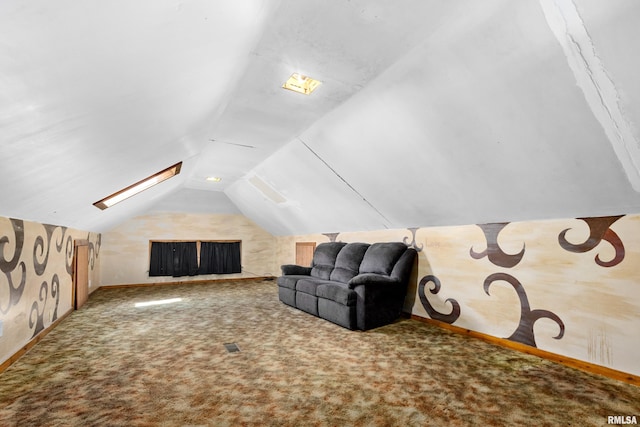 interior space featuring carpet and vaulted ceiling with skylight