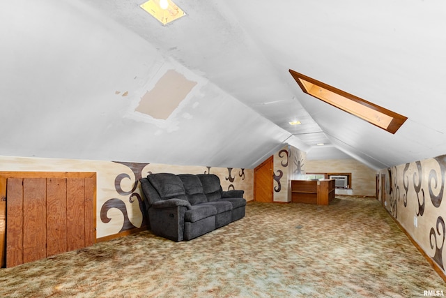 additional living space featuring carpet and lofted ceiling with skylight