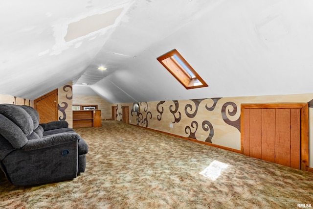 additional living space with vaulted ceiling with skylight and carpet flooring