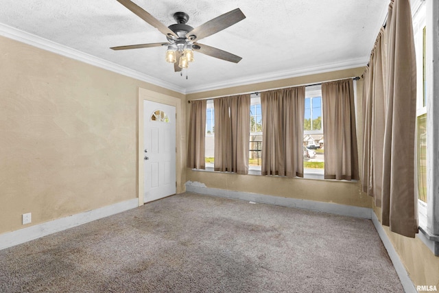 unfurnished room with a textured ceiling, ceiling fan, crown molding, and carpet floors