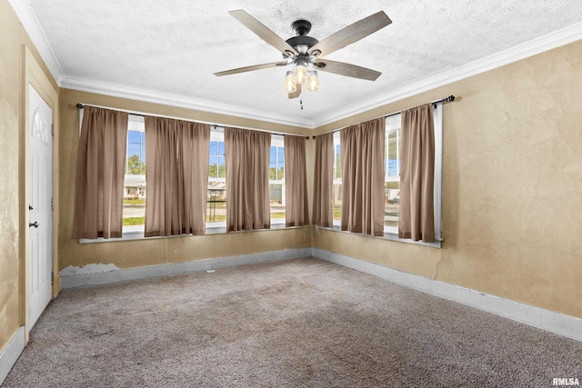 carpeted spare room featuring a textured ceiling, ceiling fan, and ornamental molding