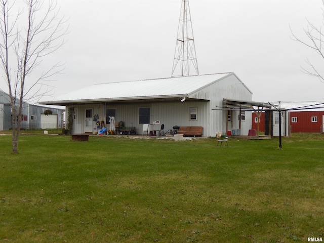 1200 E 200th St, Plymouth, IL 62367 - back of house featuring a lawn, board and batten siding, and metal roof
