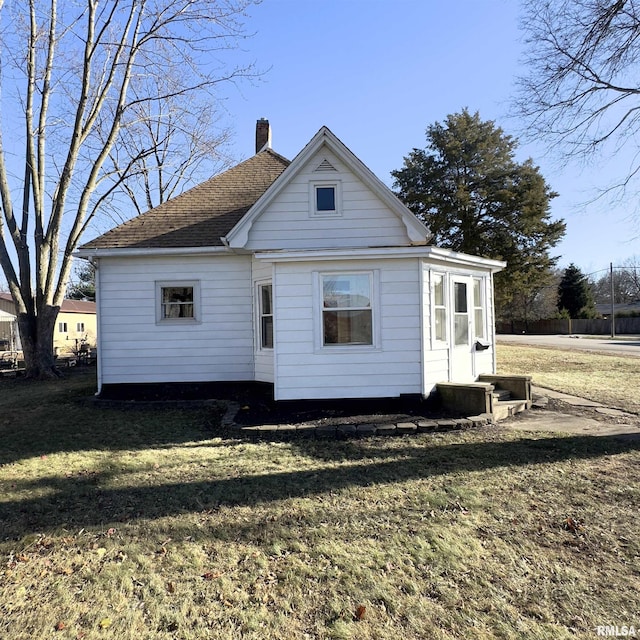 back of property featuring a lawn